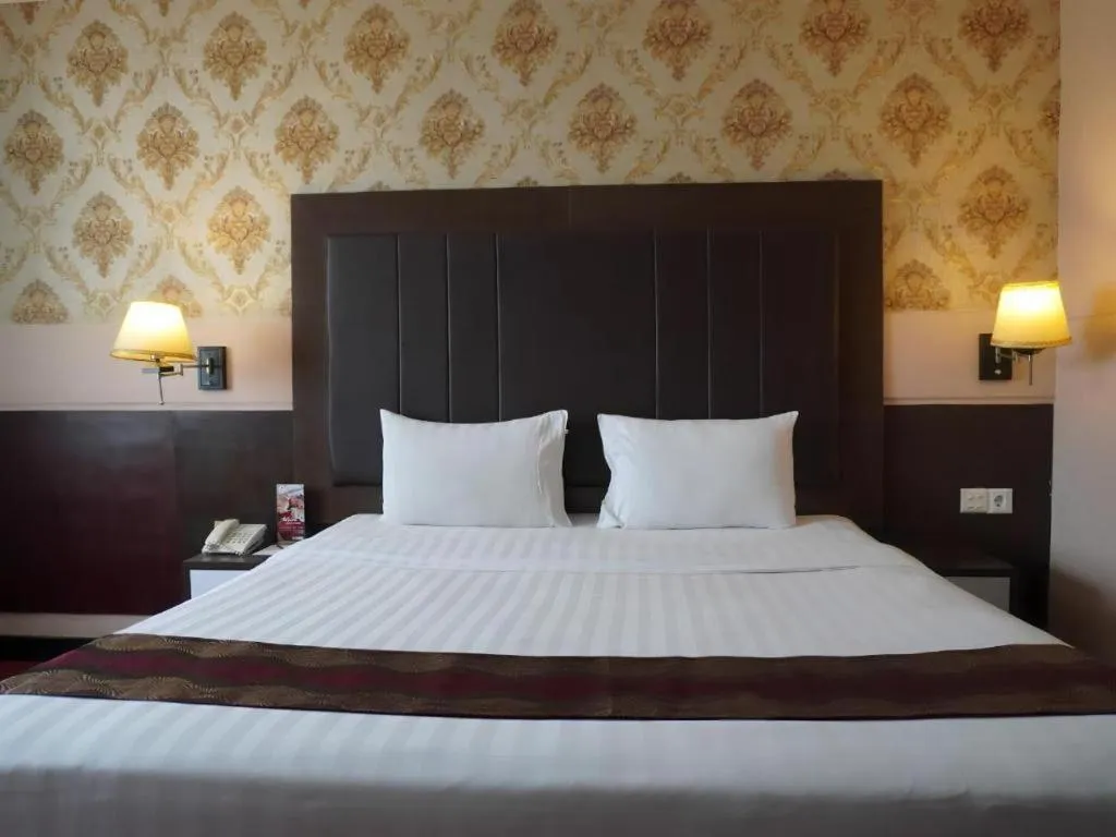 Bed in Grand Antares Hotel