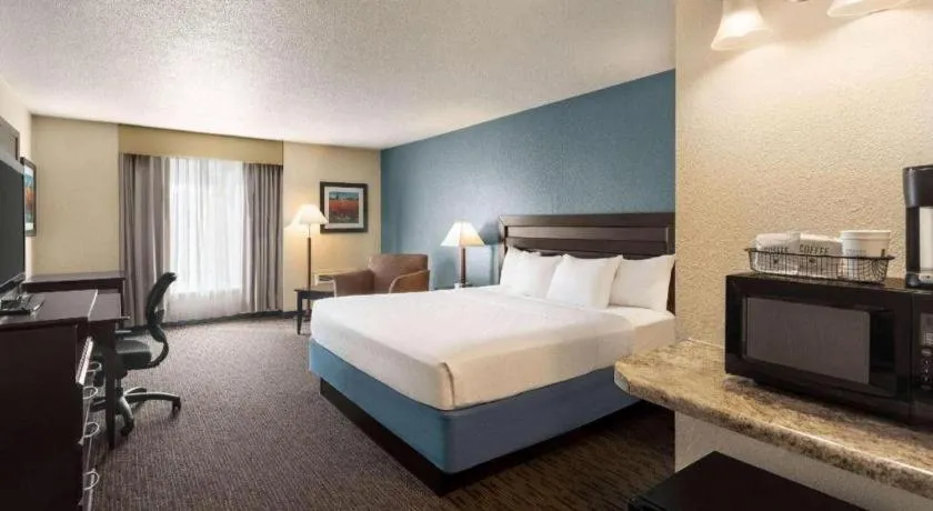 Bed in AmericInn by Wyndham La Crosse Riverfront-Conference Center