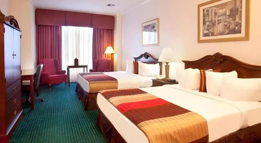 Bed in Magnuson Grand Conference Hotel