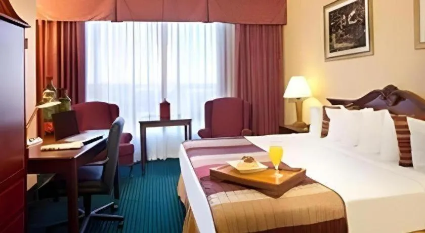 Bed in Magnuson Grand Conference Hotel