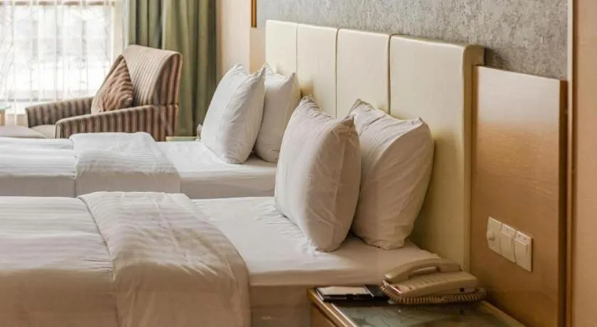 Bed in Dongguan Castfast Hotel