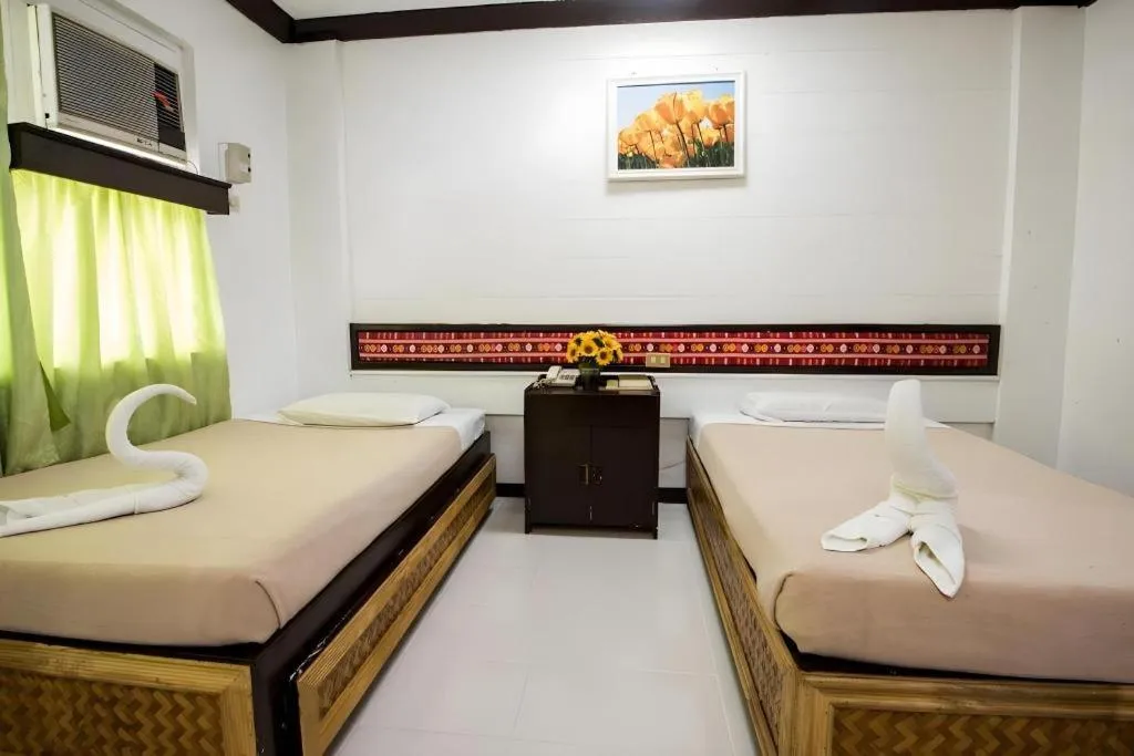 Bed in Family Country Hotel and Convention Centre