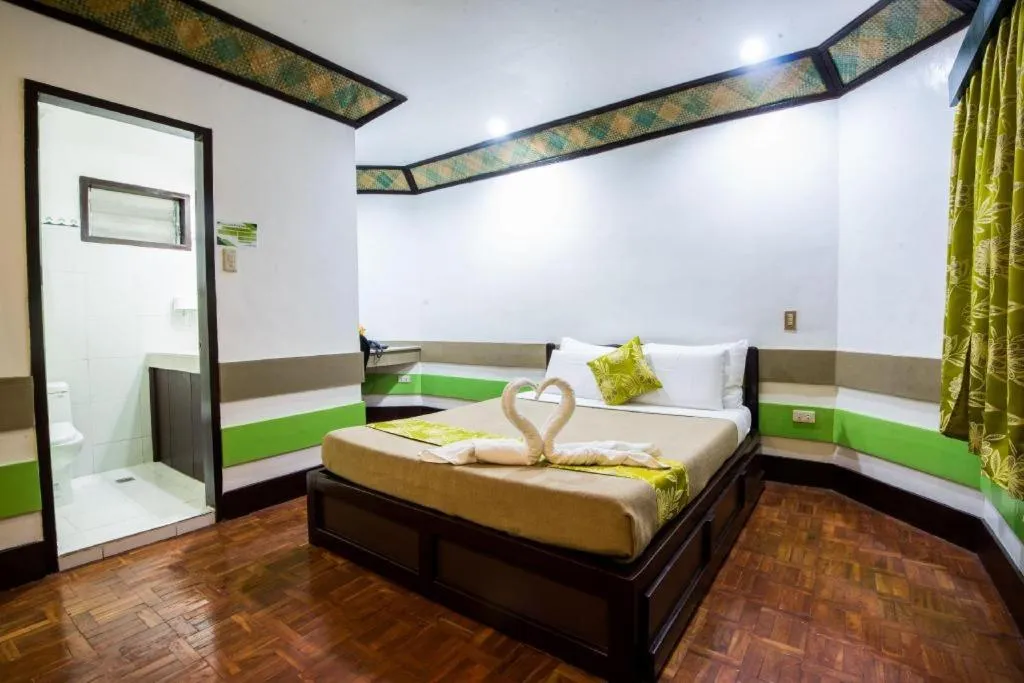 Bed in Family Country Hotel and Convention Centre