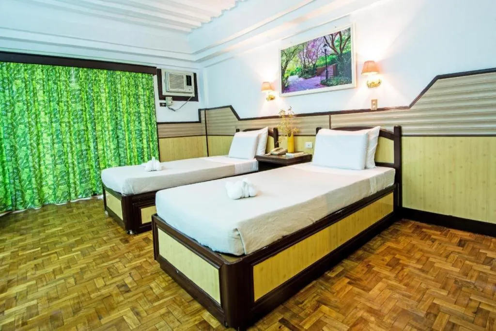 Bed in Family Country Hotel and Convention Centre