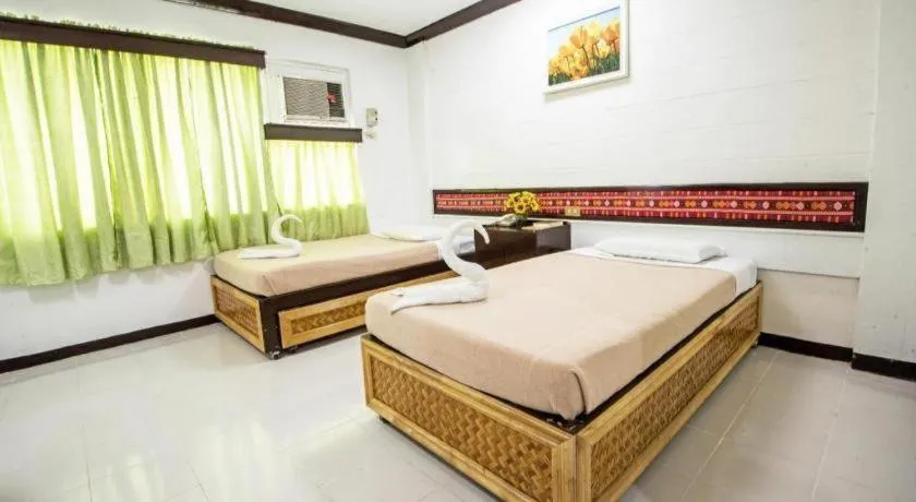 Bed in Family Country Hotel and Convention Centre