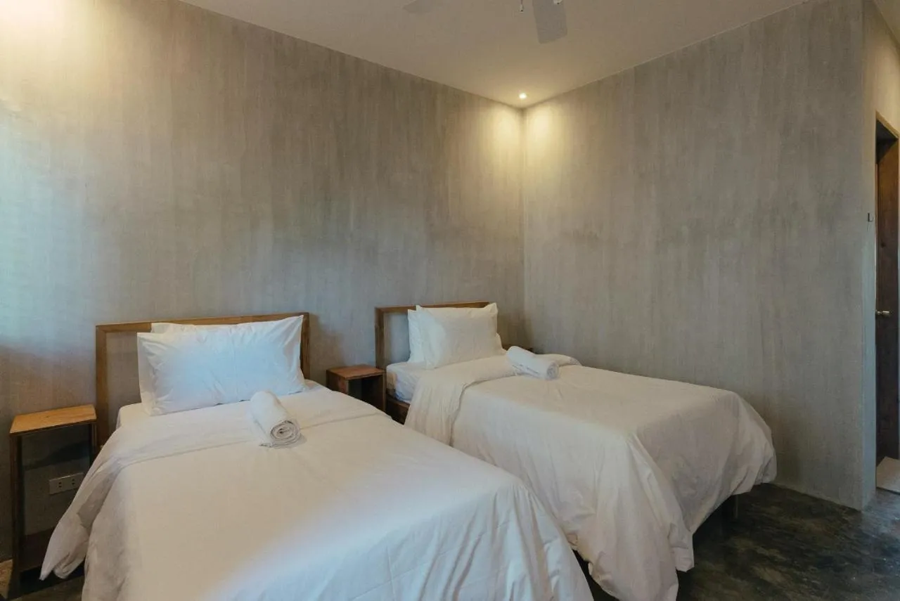 Bed in Katig Beachfront Boutique Hotel