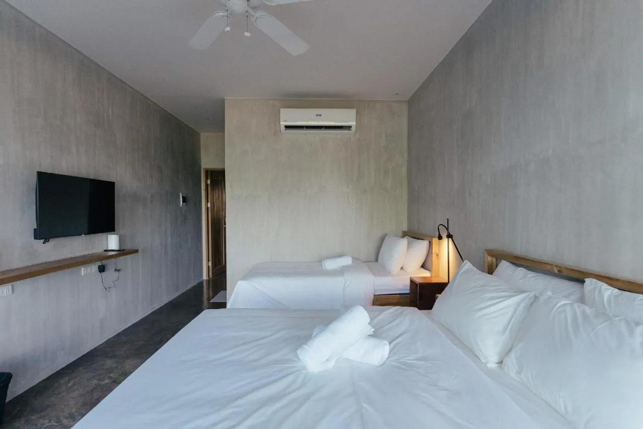 Bed in Katig Beachfront Boutique Hotel