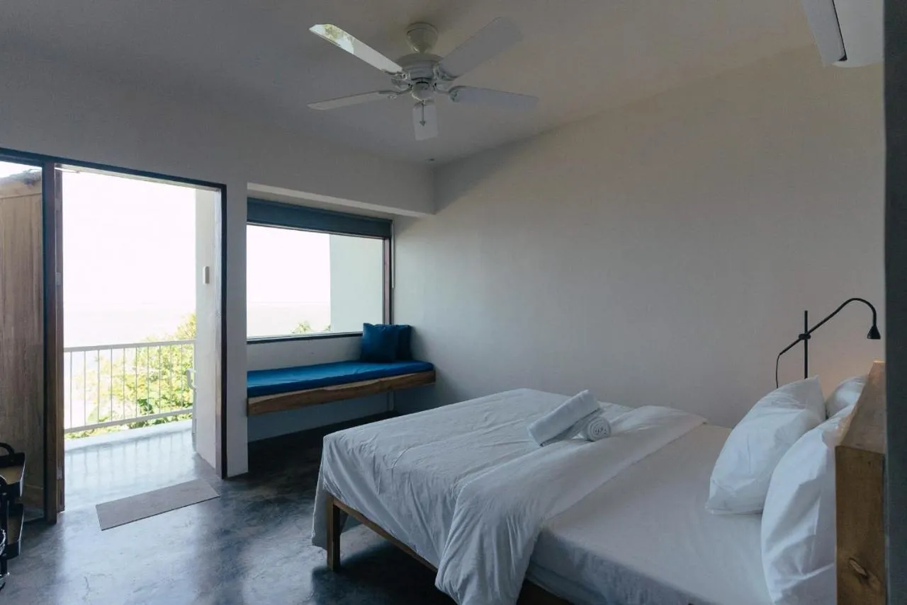 Bed in Katig Beachfront Boutique Hotel