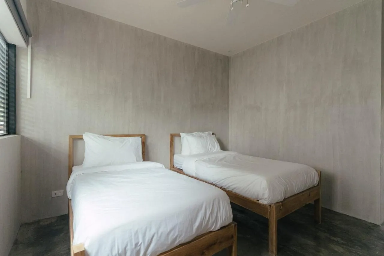 Bed in Katig Beachfront Boutique Hotel