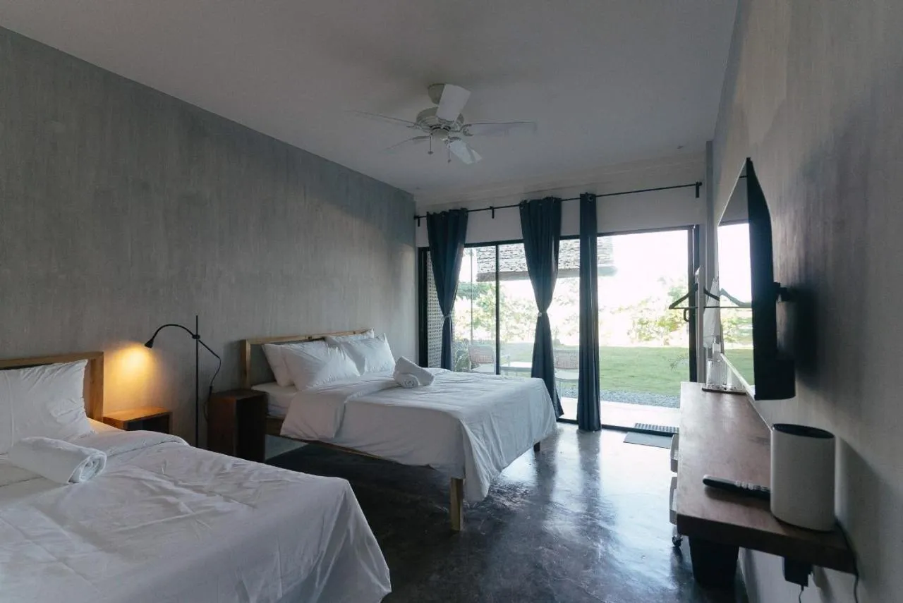 Bed in Katig Beachfront Boutique Hotel