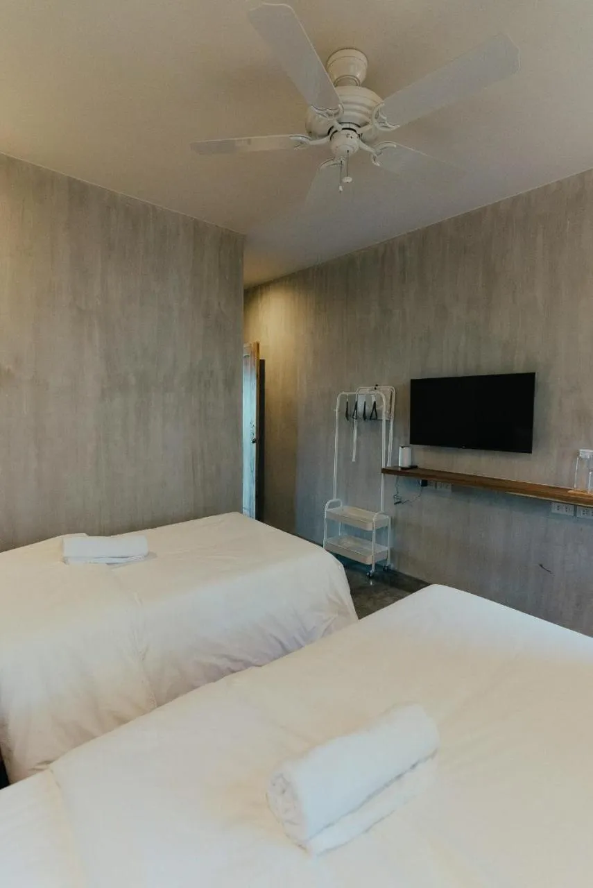Bed in Katig Beachfront Boutique Hotel