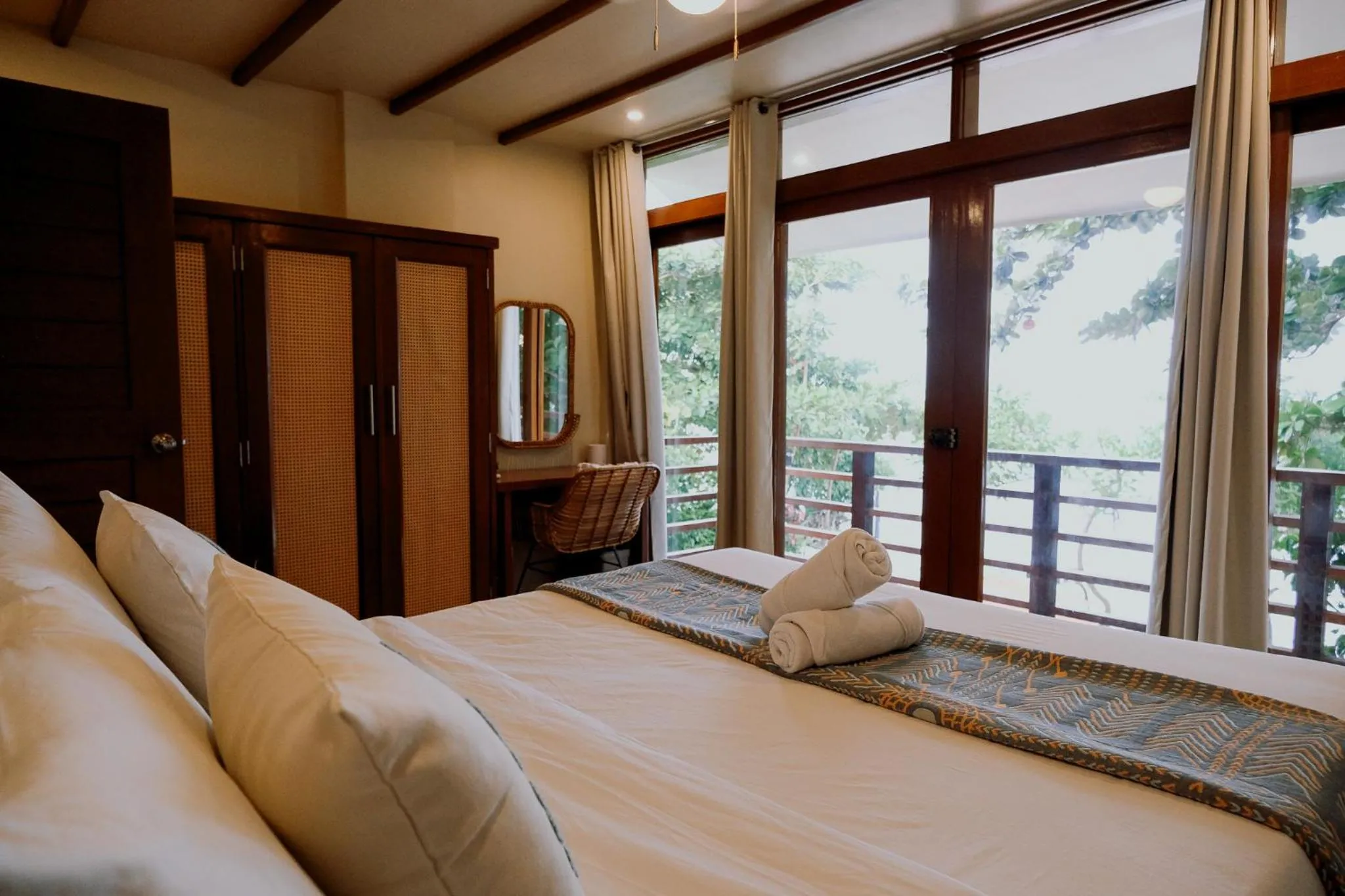 Bed in Katig Beachfront Boutique Hotel