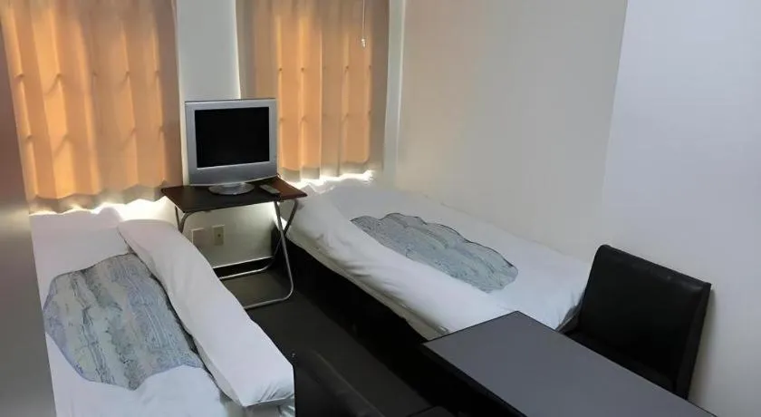 Bed in New Shochikubai Hotel