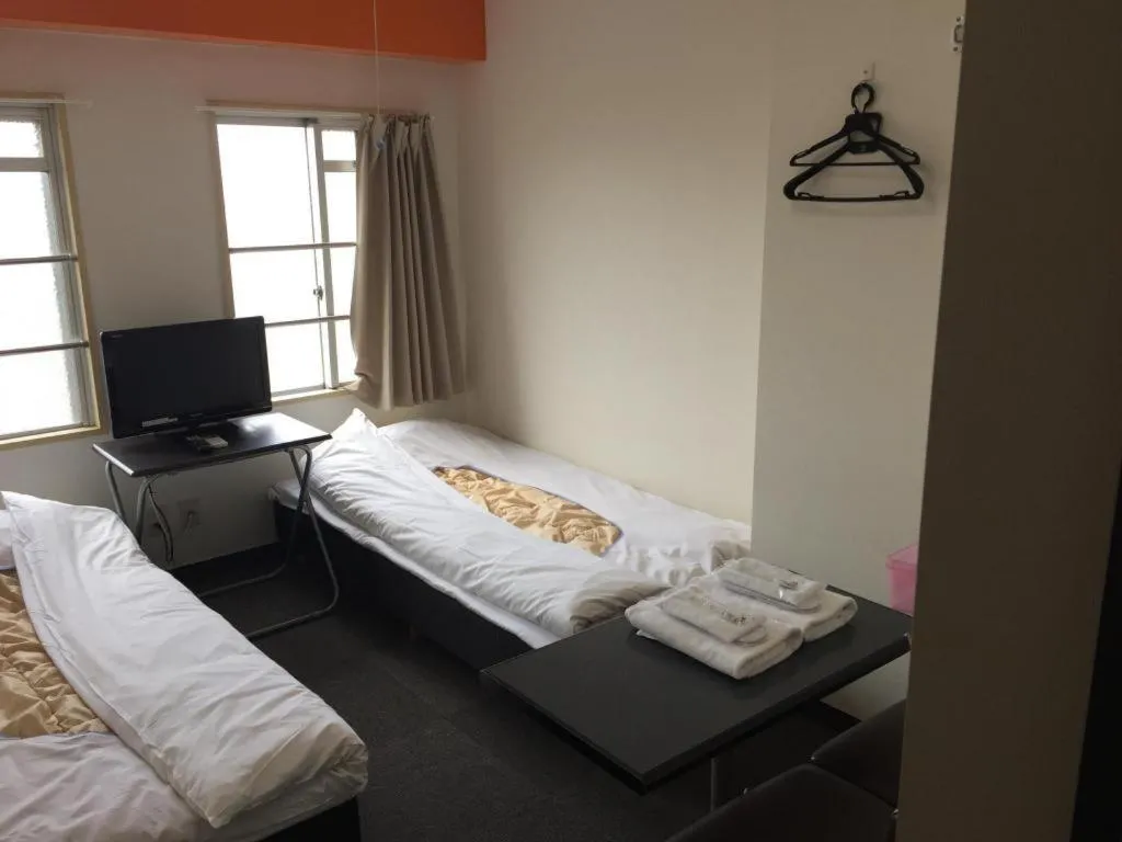 Bed in New Shochikubai Hotel