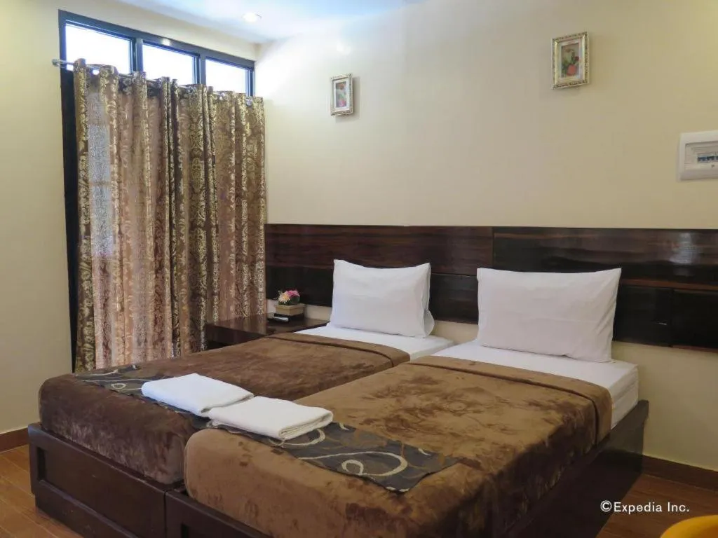 Bed in Rovic's Tourist Hotel