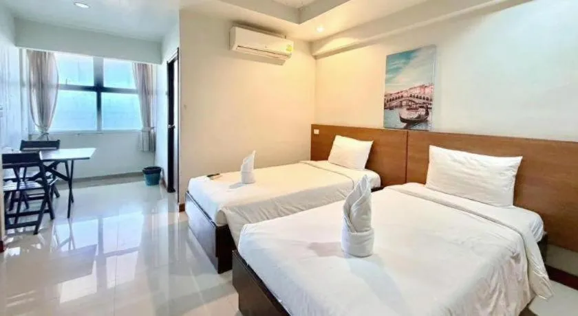 Bed in Century Grand Hotel