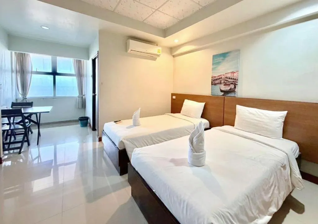 Bed in Century Grand Hotel