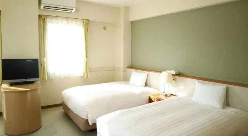 Bed in KEIKYU EX INN Yokosuka Research Park Bed in KEIKYU EX INN Yokosuka Research Park