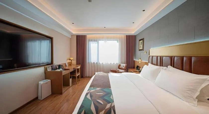 Bed in James Joyce Coffetel Xinyang Xixian Longhu Huayi