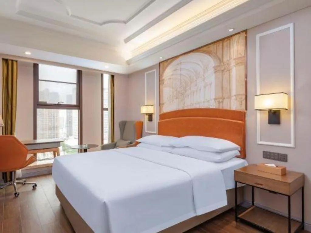 Bed in Vienna International Hotel Kunming Guangfu Road Aegean Shopping Center