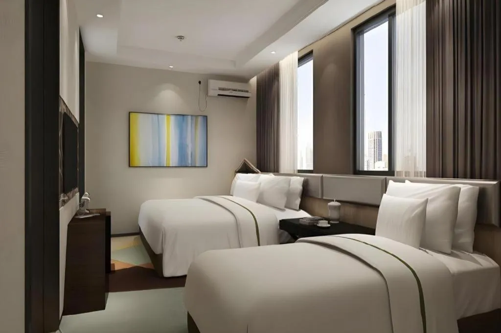 Bed in IU Hotel Qingdao Golden Beach Xuejiadao Metro Station