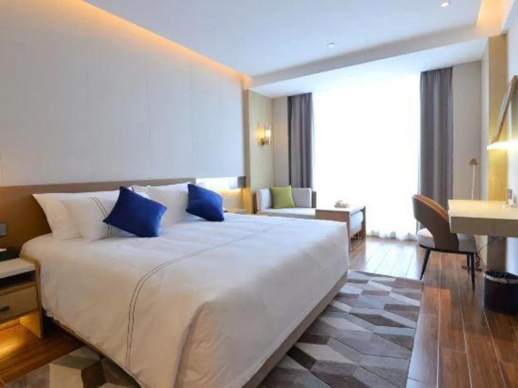 Bed in AUGUSTINE HOTEL