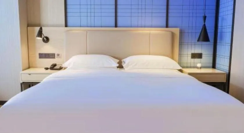 Bed in Echarm Hotel Aegean Shopping Park Zhonghuan Plaza