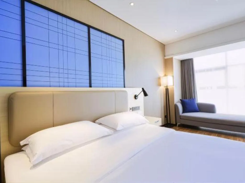 Bed in Echarm Hotel Aegean Shopping Park Zhonghuan Plaza