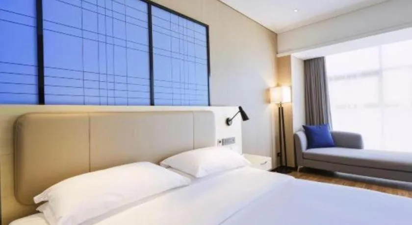 Bed in Echarm Hotel Aegean Shopping Park Zhonghuan Plaza