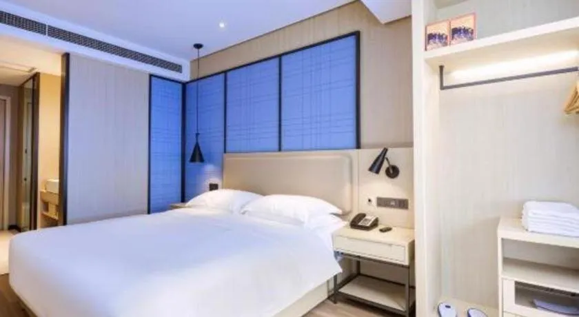 Bed in Echarm Hotel Aegean Shopping Park Zhonghuan Plaza