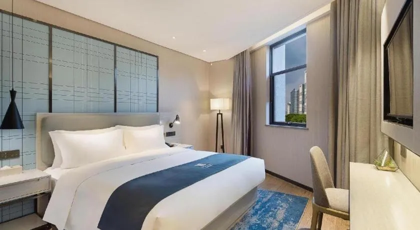Bed in Echarm Hotel Changsha Guihua Park Metro Station