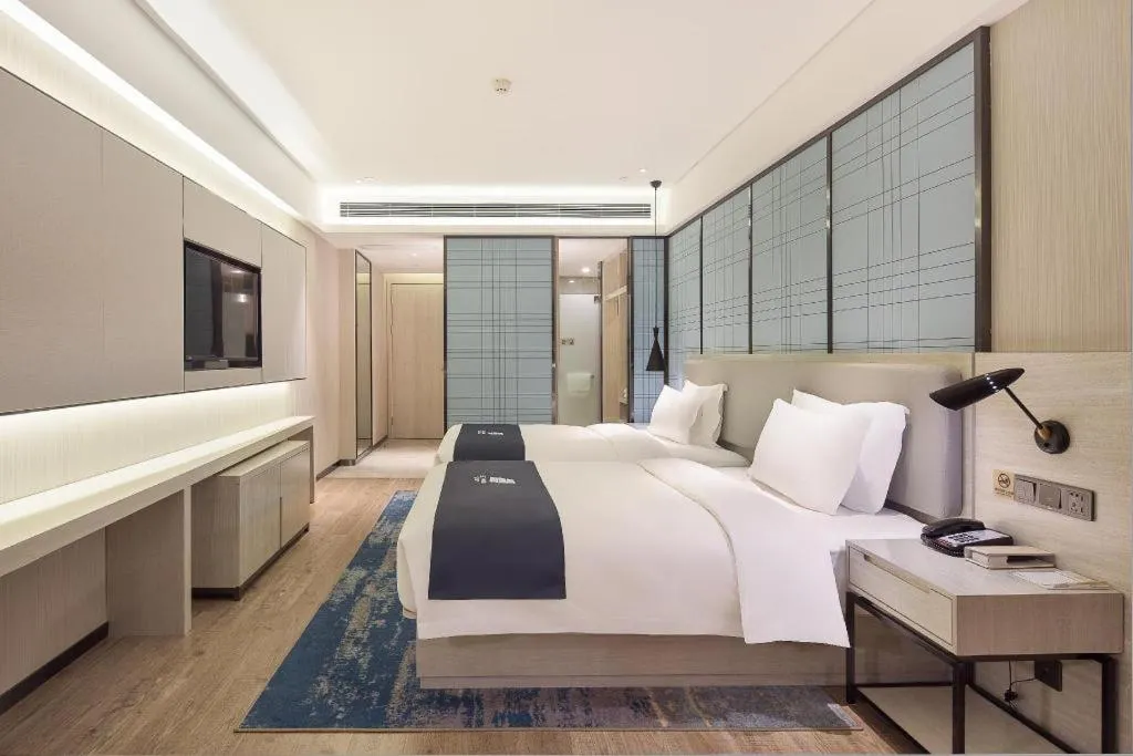 Bed in Echarm Hotel Changsha Guihua Park Metro Station