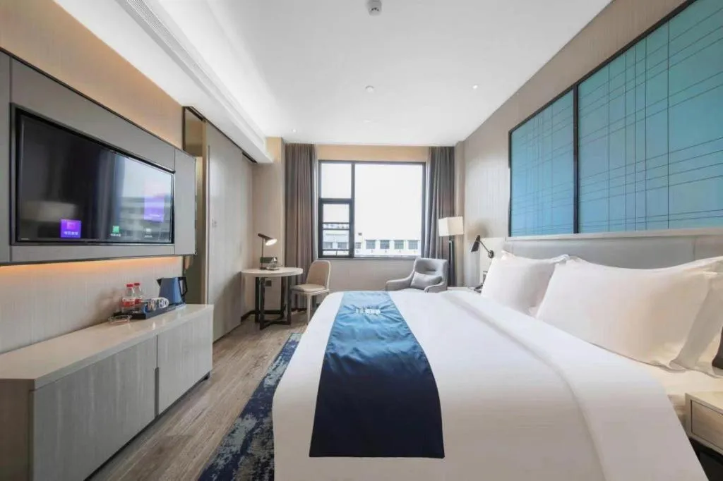 Bed in Echarm Hotel Xinyu Railway Station Baoshi Park