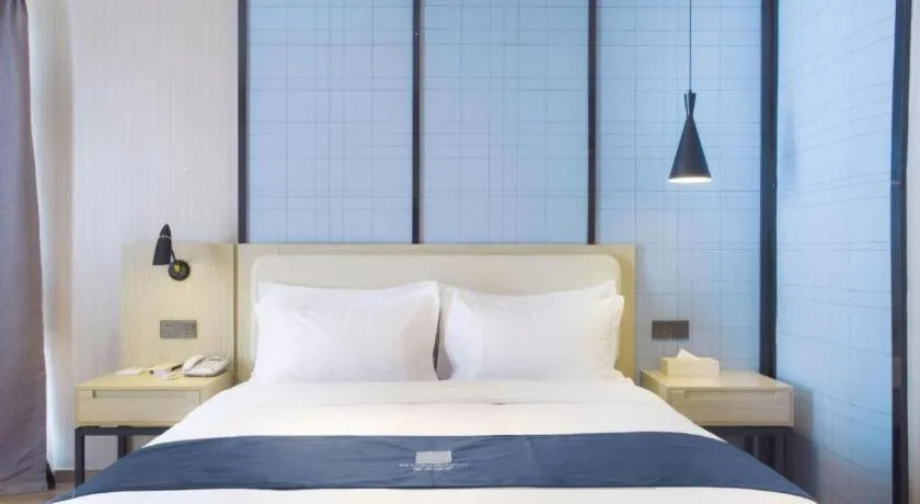 Bed in Echarm Hotel Xinyu Railway Station Baoshi Park