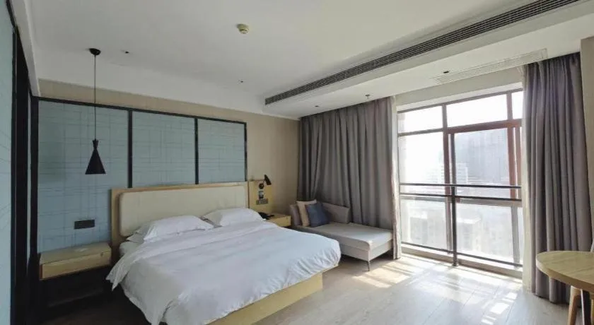 Bed in Echarm Hotel Xinyu Railway Station Baoshi Park