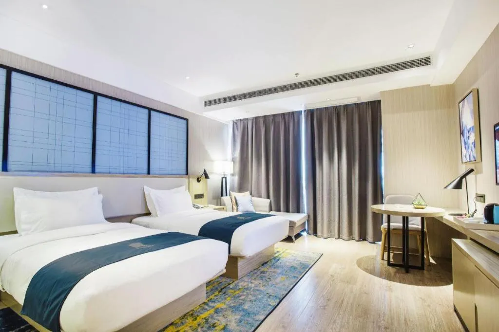 Bed in Echarm Hotel Xinyu Railway Station Baoshi Park