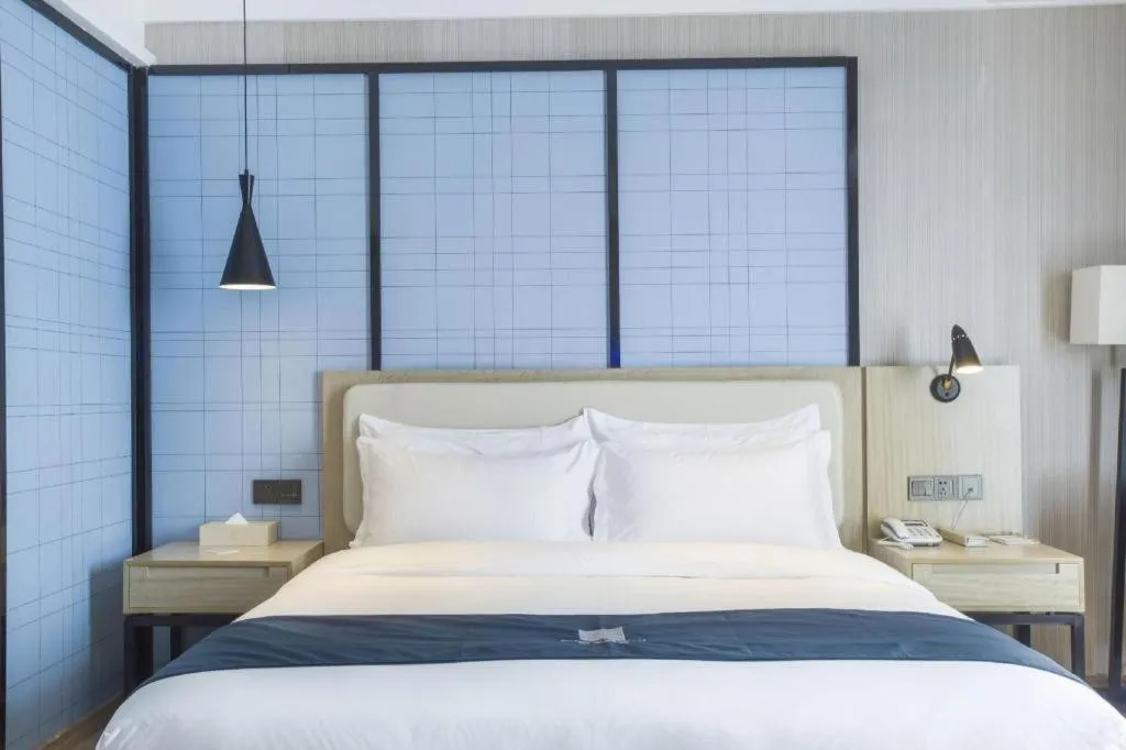 Bed in Echarm Hotel Xinyu Railway Station Baoshi Park