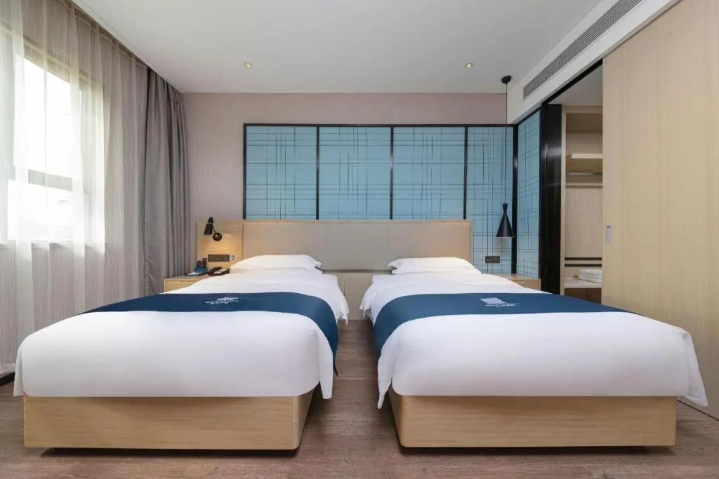 Bed in Echarm Hotel Xinyu Railway Station Baoshi Park