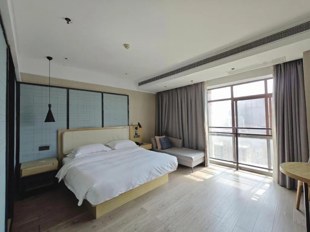 Bed in Echarm Hotel Xinyu Railway Station Baoshi Park