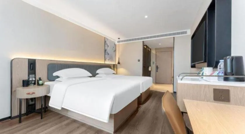 Bed in Echarm Hotel Wuhan Vanke Future Center Wulidun Metro Station