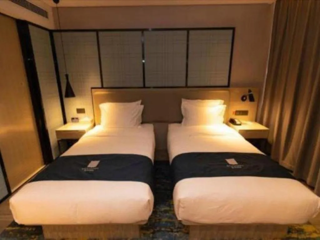 Bed in Echarm Hotel Zibo Gaoqing Zhongcheng Inernational