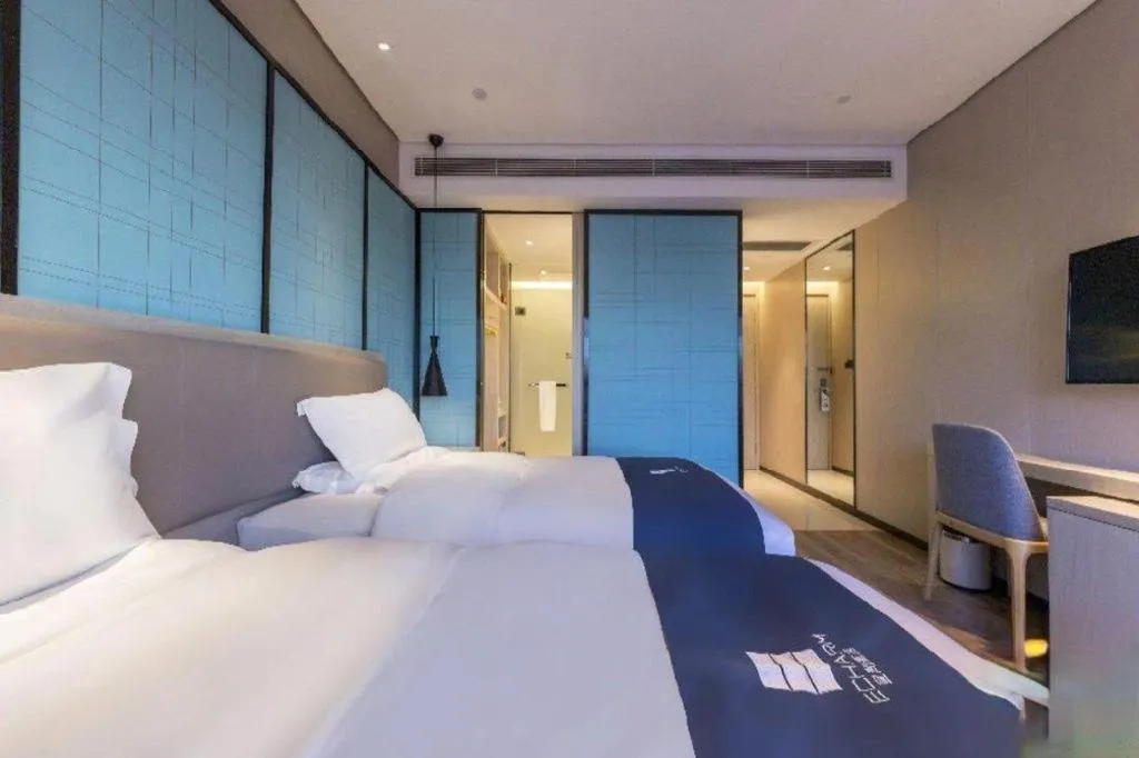 Bed in Echarm Hotel Kunming Railway Station Huancheng South Road Metro Station