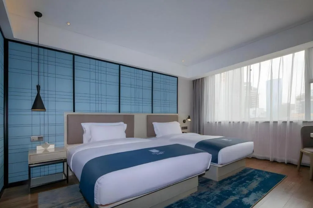 Bed in Echarm Hotel Kunming Railway Station Huancheng South Road Metro Station