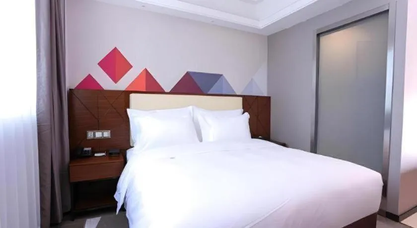 Bed in Borrman Hotel Guangzhou Railway Station Sanyuanli Metro Station