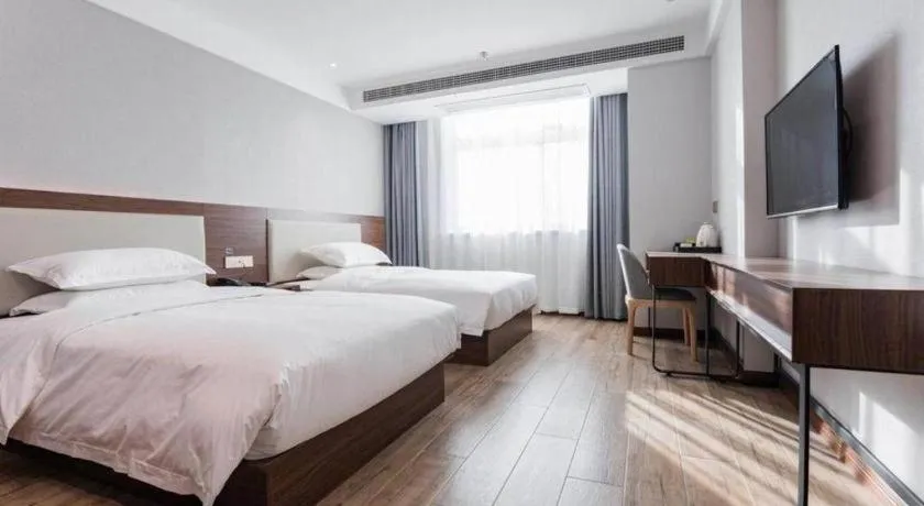 Bed in Borrman Hotel East Huai'an Railway Station Zhou 'Enlai Memorial