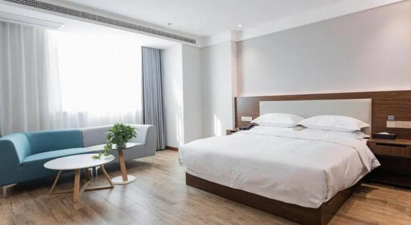 Bed in Borrman Hotel East Huai'an Railway Station Zhou 'Enlai Memorial