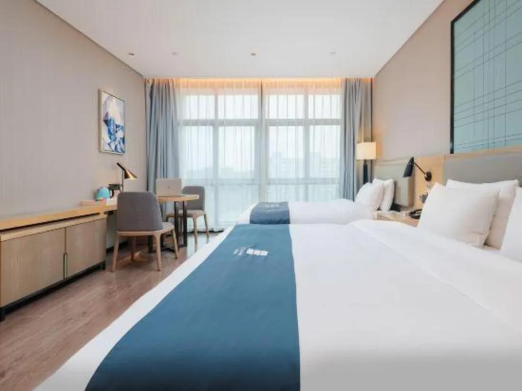 Bed in Echarm Hotel Liuzhou Liunan Wanda Plaza