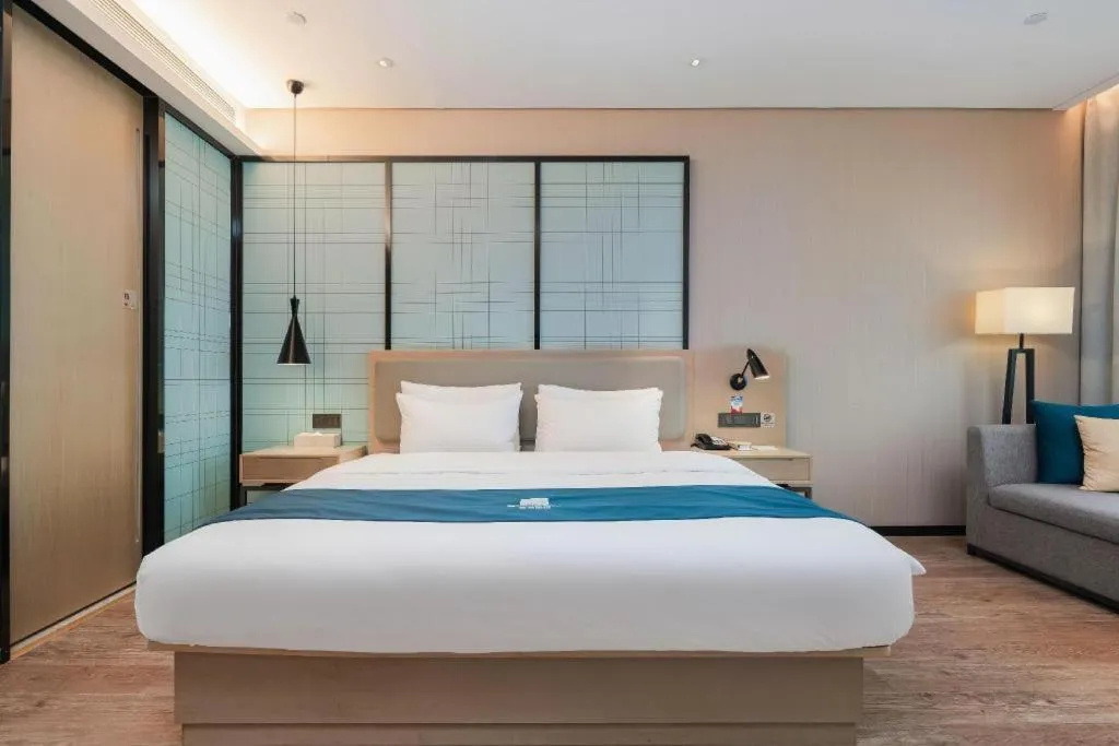 Bed in Echarm Hotel Liuzhou Liunan Wanda Plaza