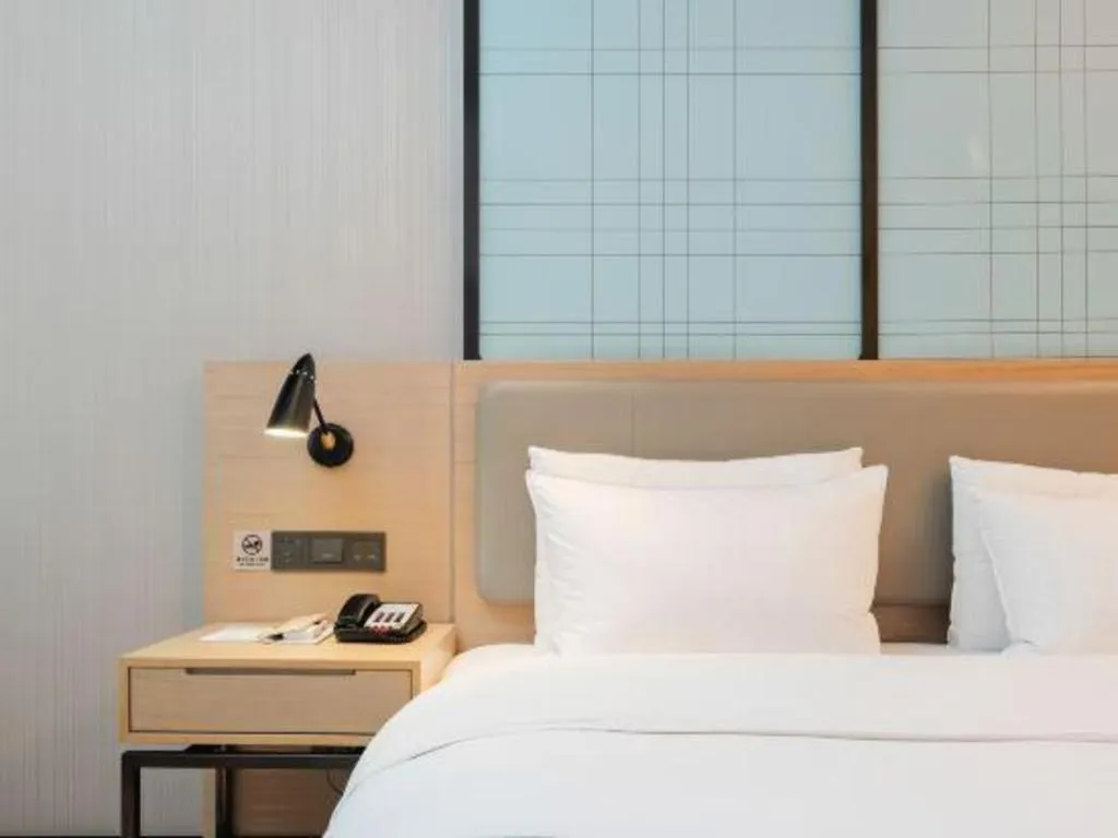 Bed in Echarm Hotel Liuzhou Liunan Wanda Plaza