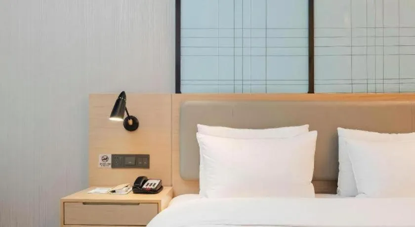 Bed in Echarm Hotel Liuzhou Liunan Wanda Plaza
